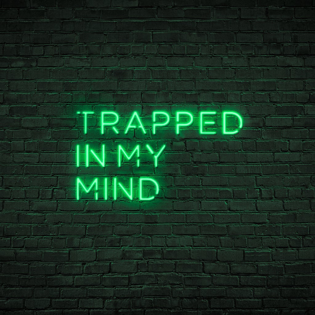 Néon citation "Trapped in my mind" avec couleur verte